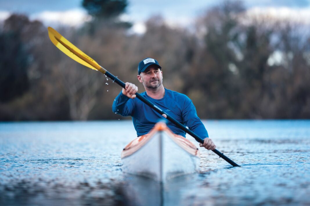 man kayaking on a lake