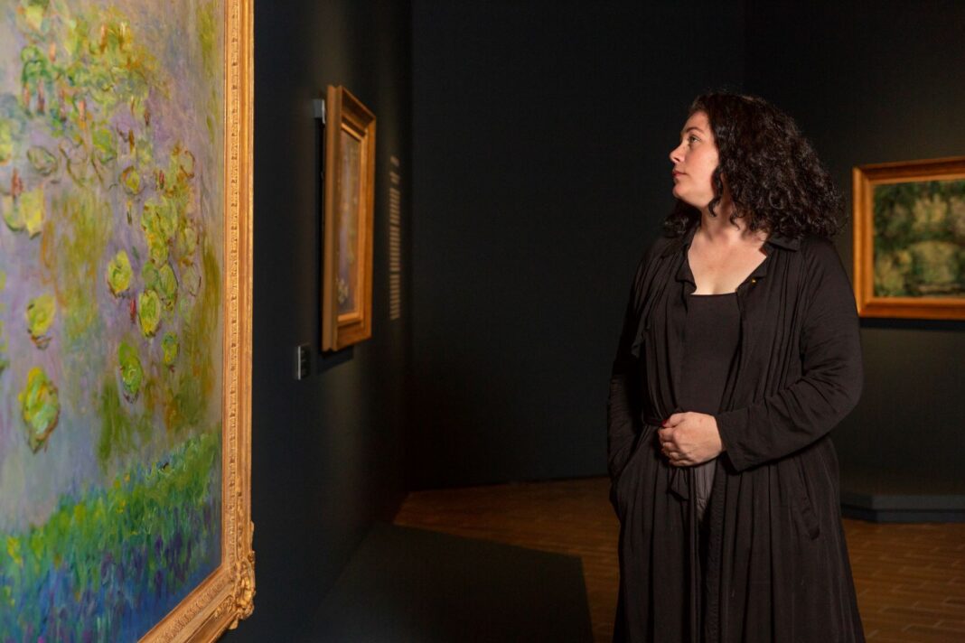 woman looking at painting