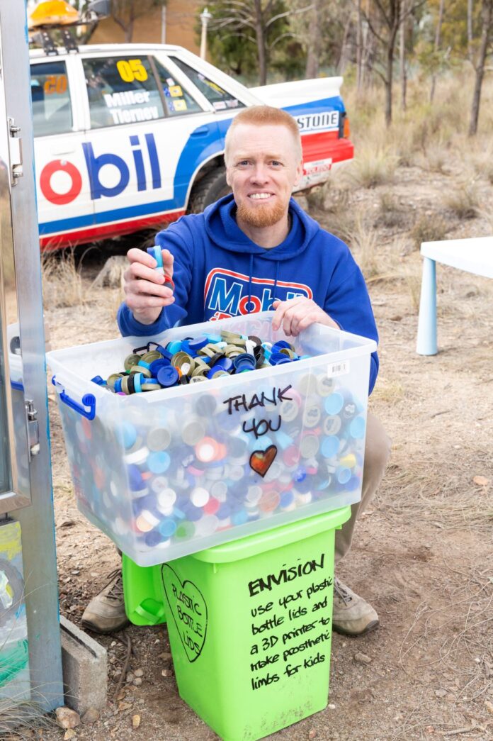 man with donated plastic lids