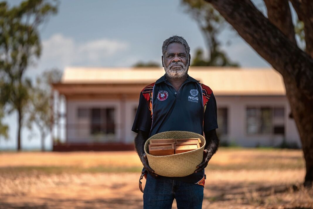 aboriginal man holding basket