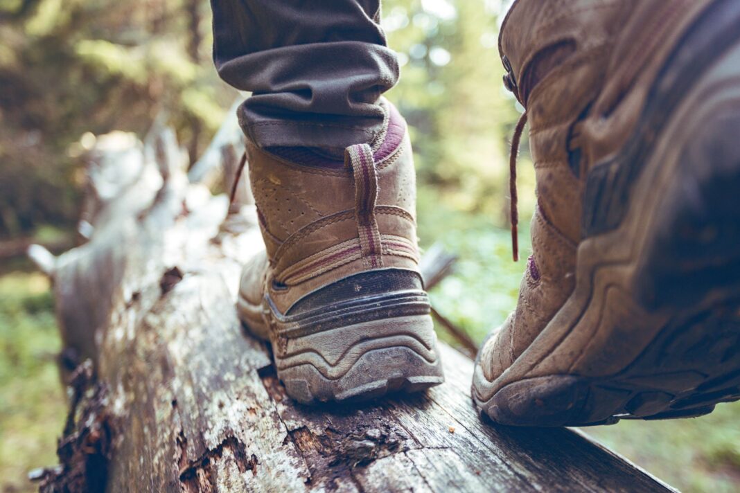 close up of boots walking on a log
