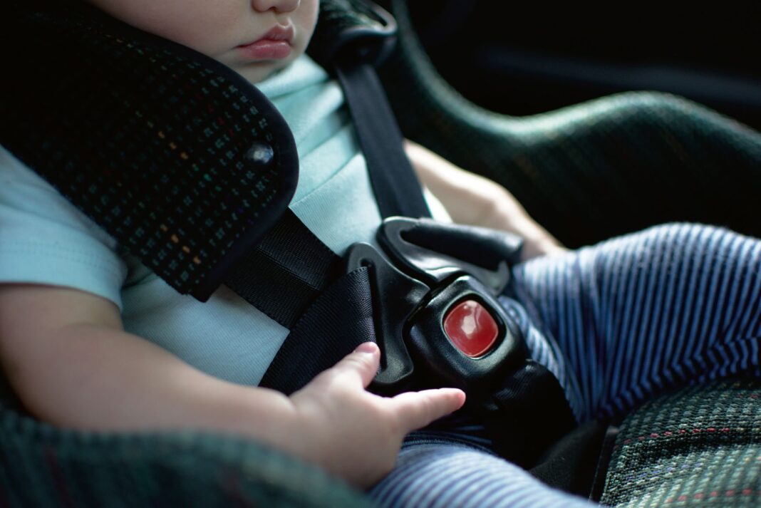 small baby buckled in car seat