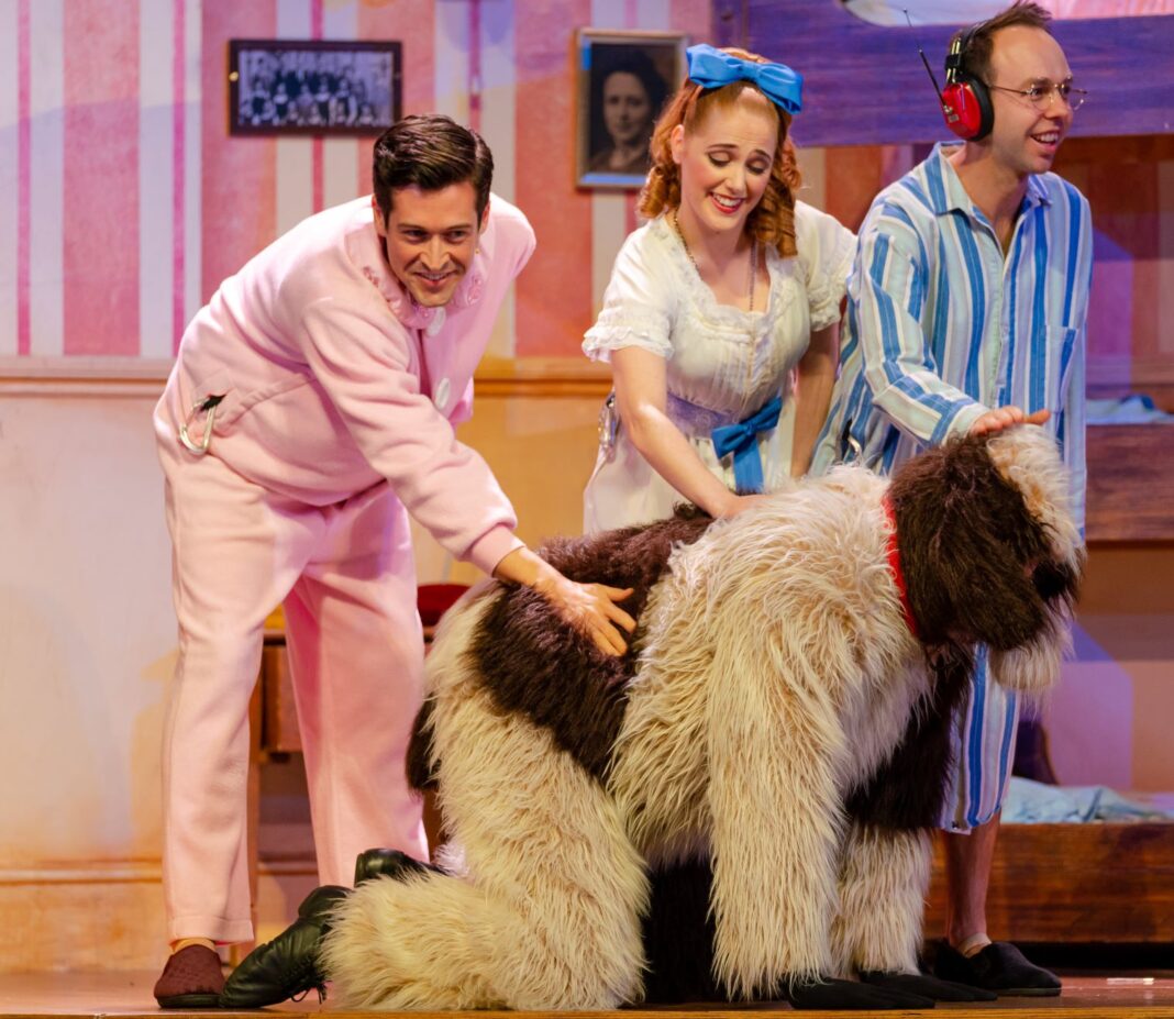 three people on stage in a show with another dressed as a dog