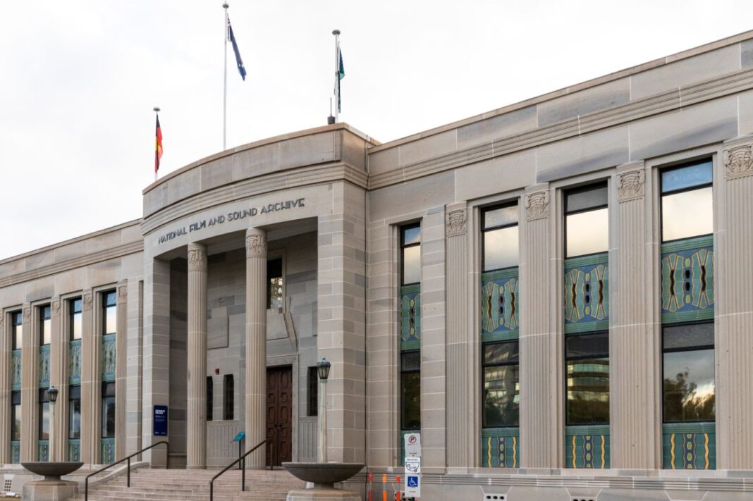Exterior of the National Film and Sound Archive in Canberra, an historic sandstone building with Grecian columns at the front entrance