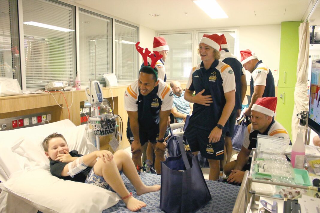 Brumbies players talking to kids at a hospital