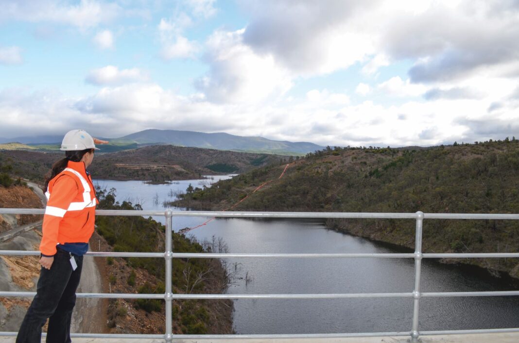 woman looking over large dam