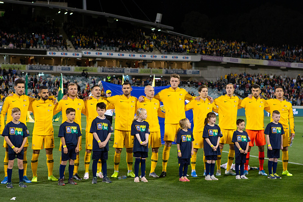 socceroos players lined up for the national anthem