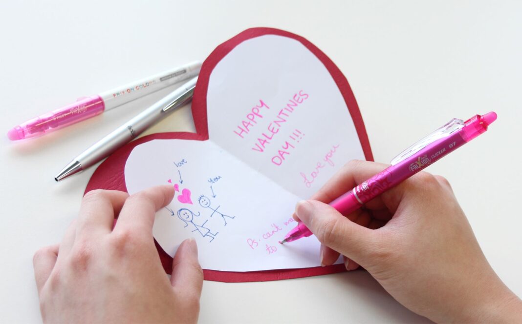 close up of writing a Valentines Day card