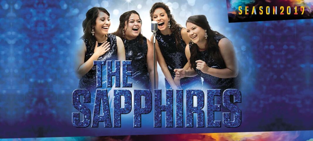 The Sapphires singing into a microphone
