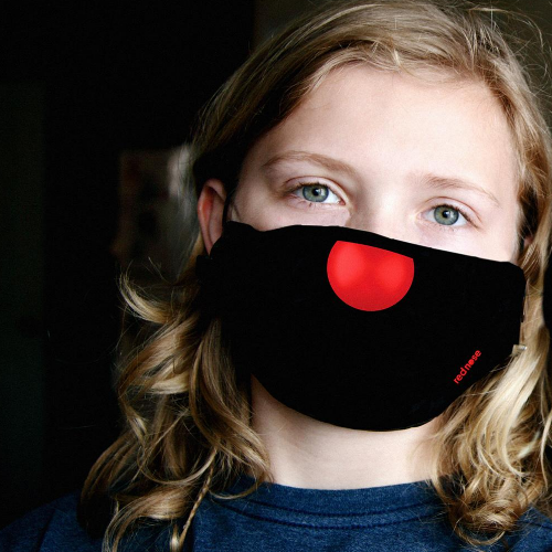 Woman wearing black face mask with red nose on the tip
