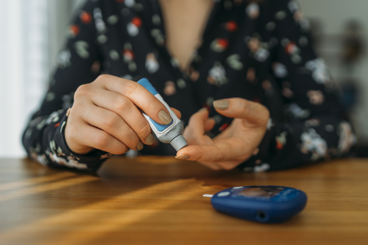 Woman with diabetes doing blood glucose measurement