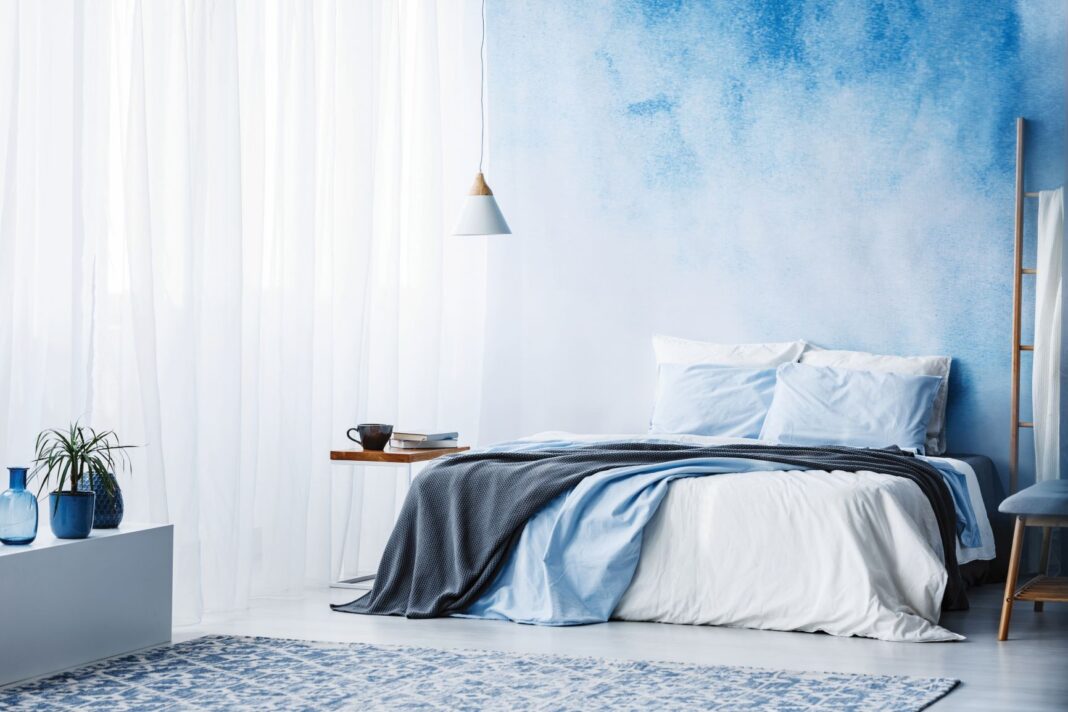 blue wall and sheets on bed