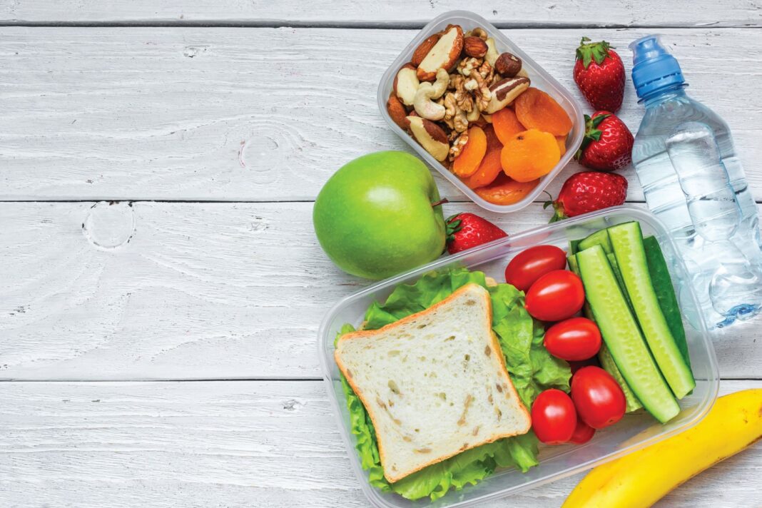lunch box with sandwich, fruit and water