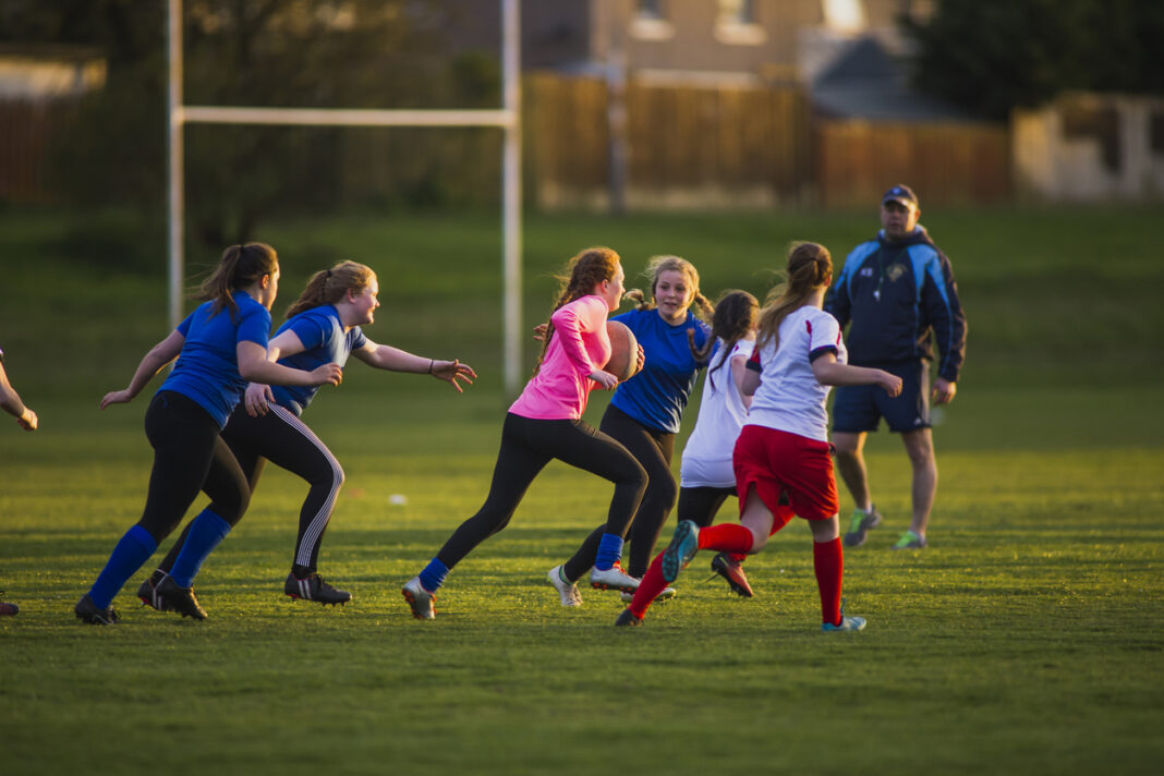 Teen Girls Playing a Game of Rugby