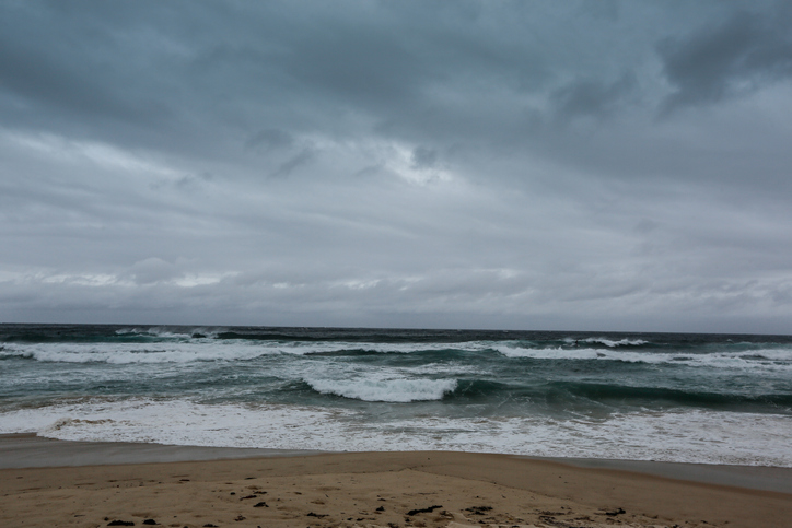 Stormy beach with cloudy grey skies