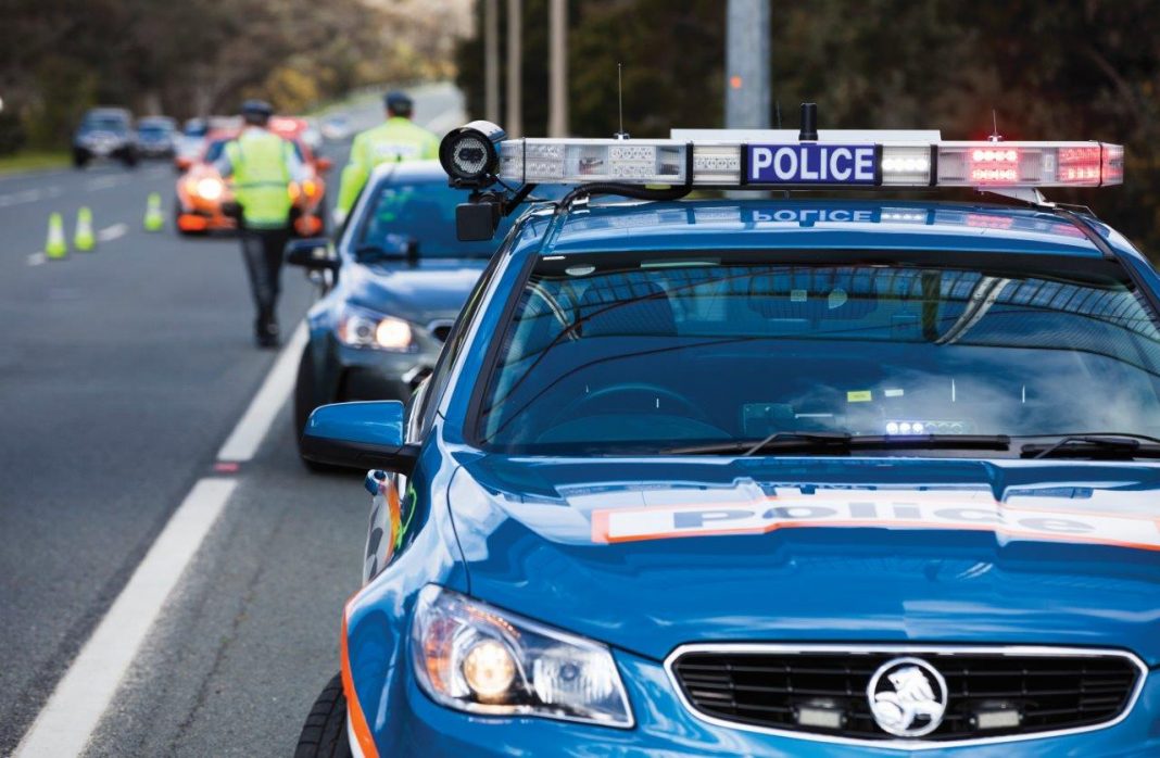 ACT police cars and officers conducting roadside breath testing