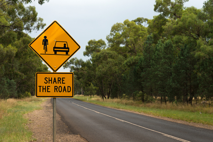 Share the road with cyclists bike riding trail Australian warning road sign