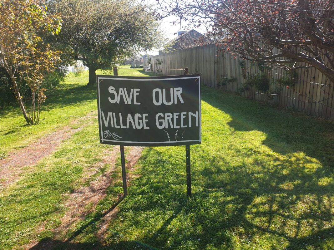sign reading 'save our village green'