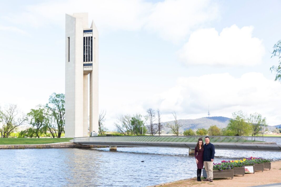 couple standing next to lake burley griffin