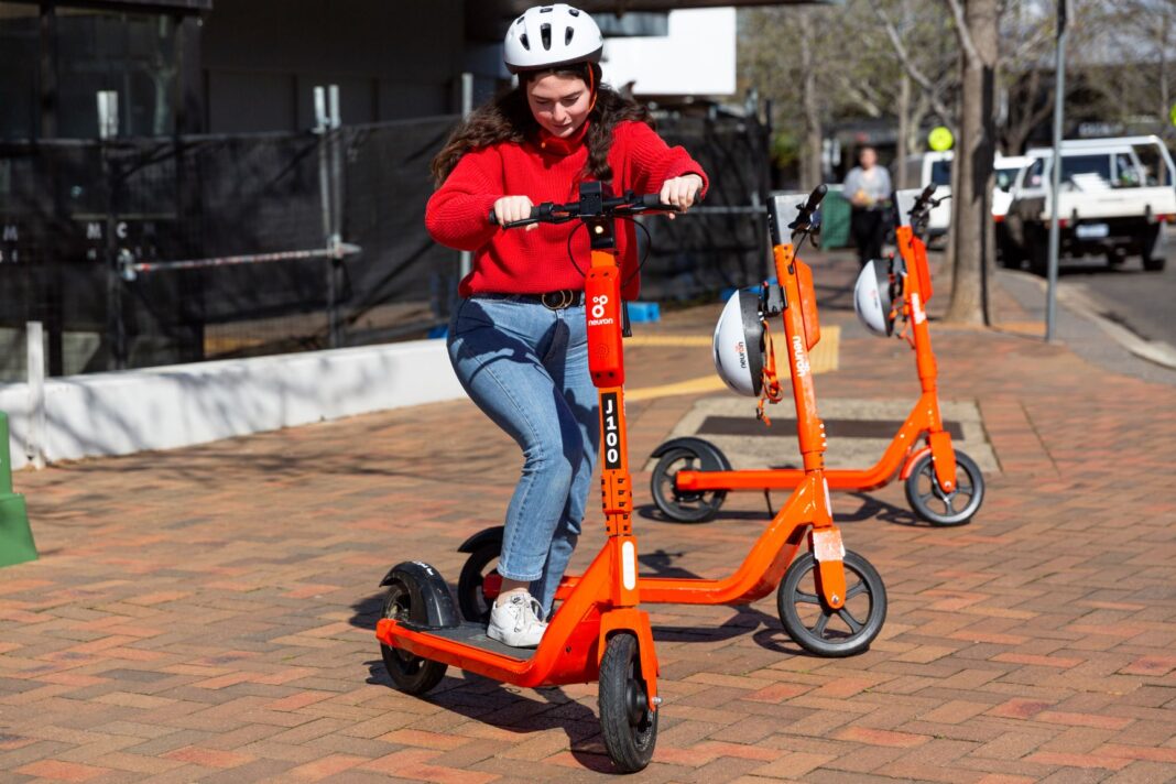 Danielle Meddemmen test riding one of the new shared e-scooters available
