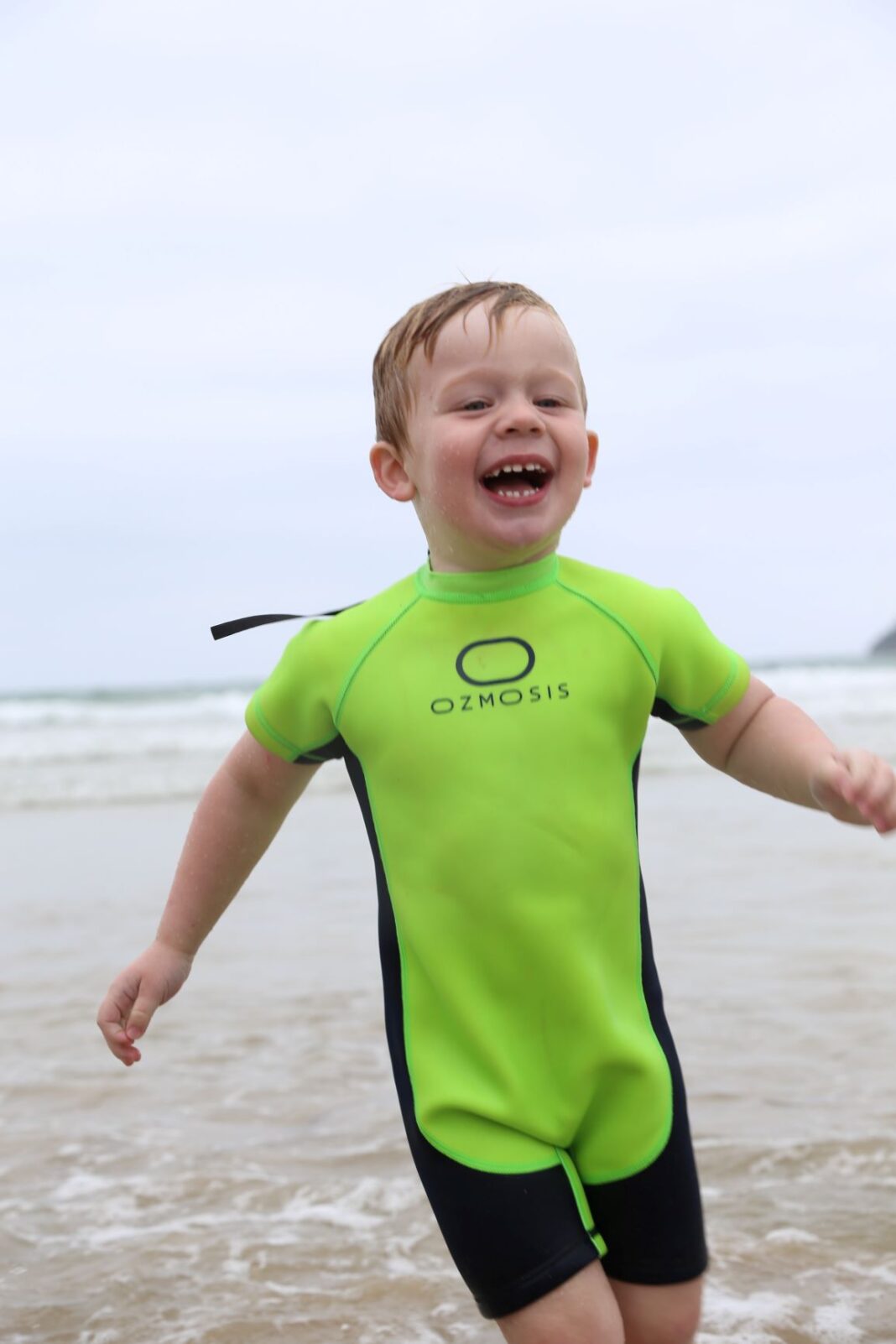 young boy smiling at the beach