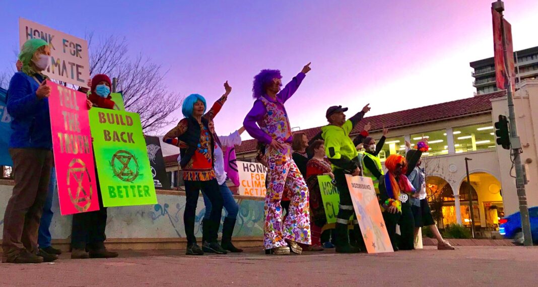 climate change protestors dressed in disco gear