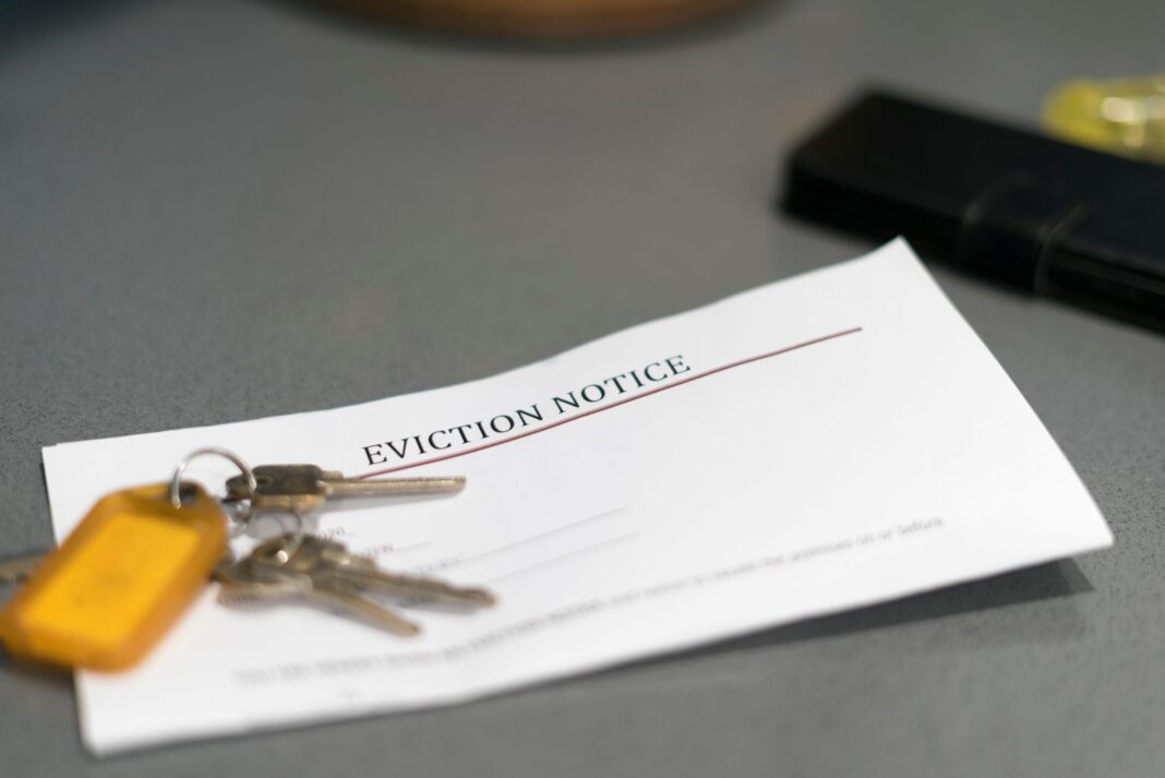 Paper with the words 'eviction notice' and a set of keys