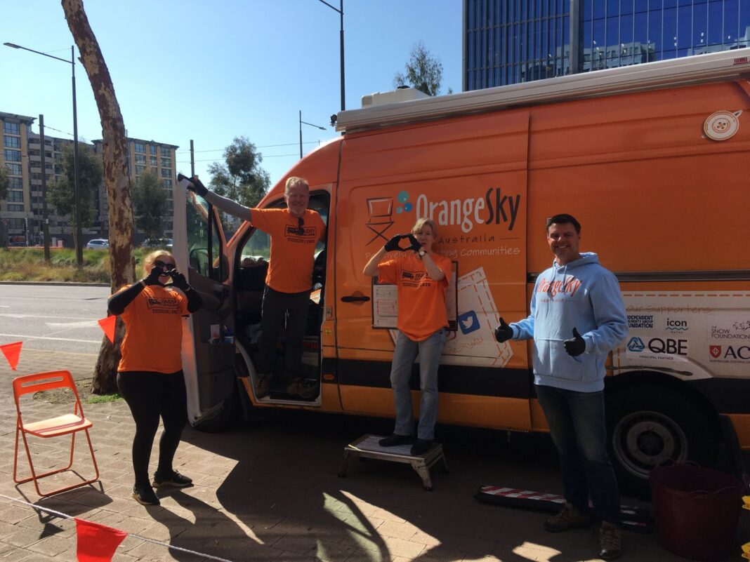Orange Sky Laundry Canberra Volunteers Nicole Vonarx, Kevin Jones, Hilary Thomson and David Heatley in front of their orange van