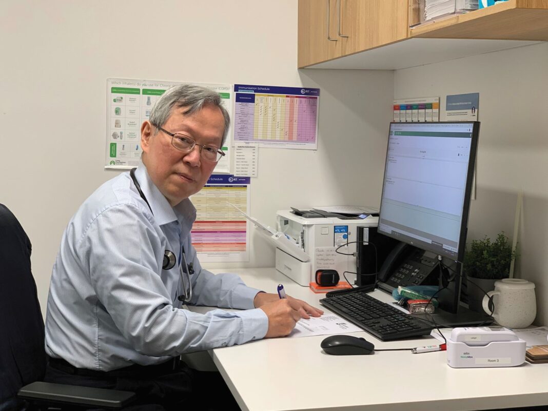 Dr Li working at his desk