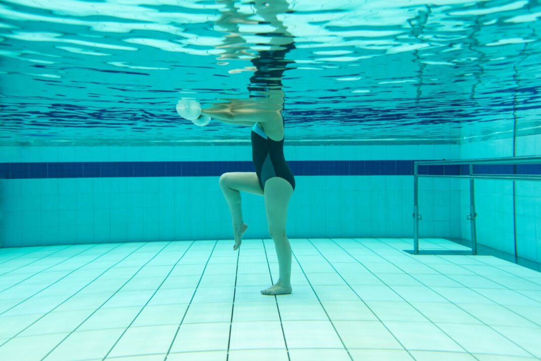 A woman performs exercises in a hydrotherapy pool