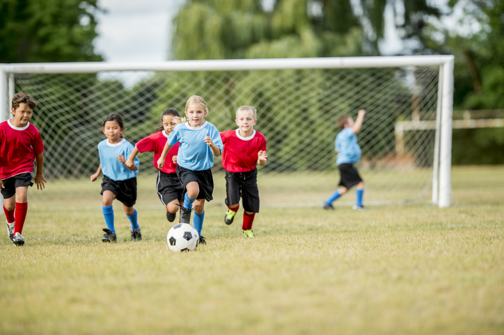 community sport children soccer chasing the ball