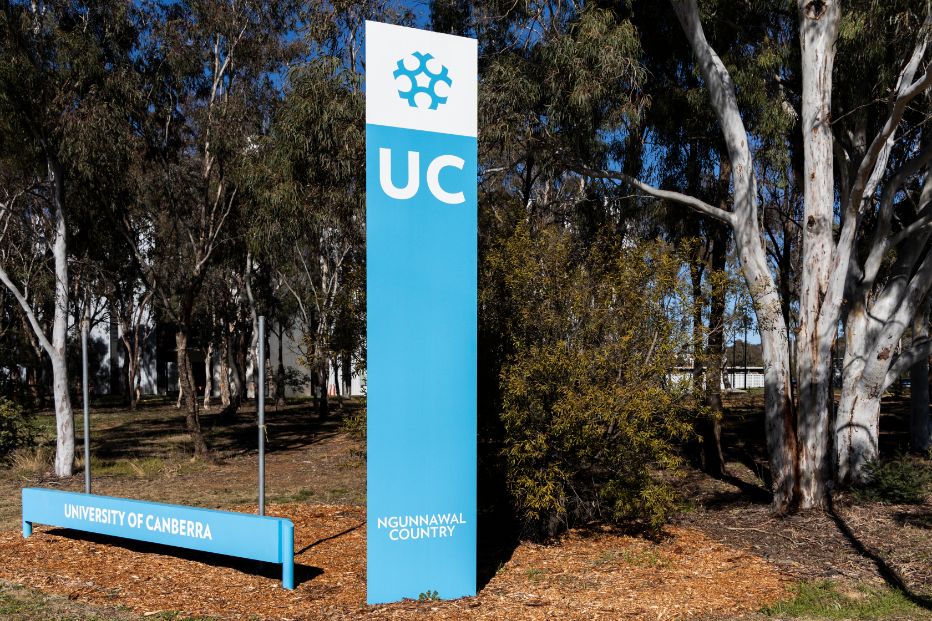 Uc sign next to trees
