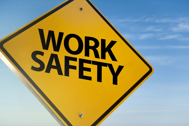 Stock image of a yellow sign that reads 'work safety'