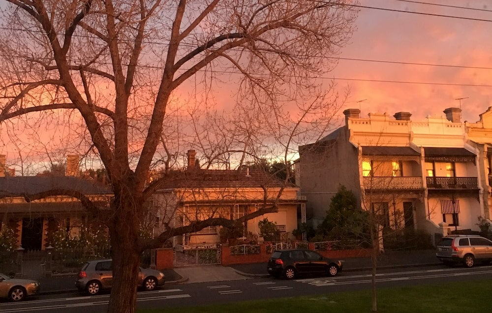 A view of the sun setting over terrace houses in Melbourne during lockdown.