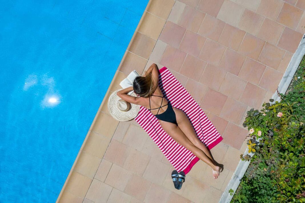 woman lounging by the pool