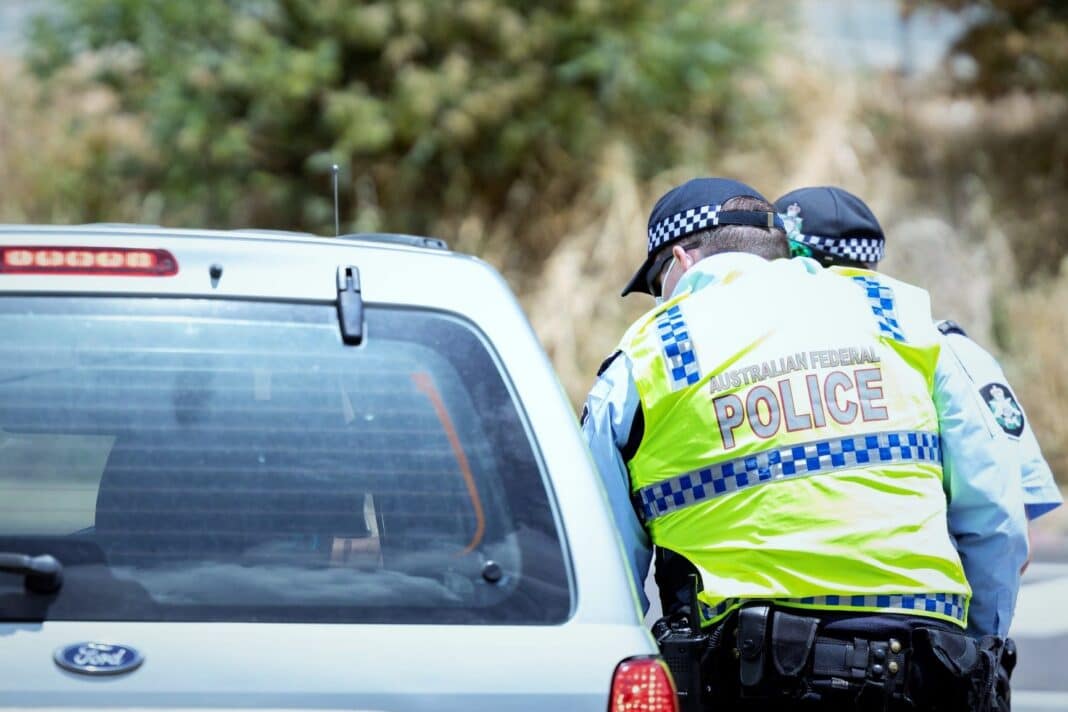 ACT Policing speak to a driver at a border checkpoint.