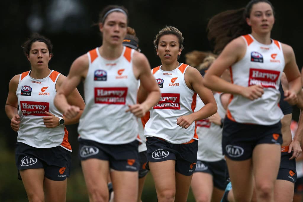 group of Giants AFLW players running