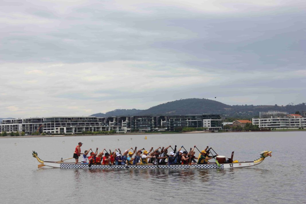 crew of men and women in a dragon boat on Lake Burley Griffin