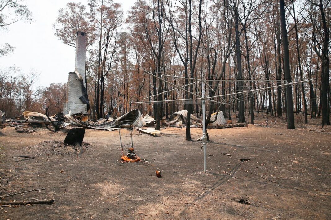 The wreckage of a building in Mogo after last year's bushfires. There are calls for the HomeBuilder scheme to be extended for bushfire-affected residents