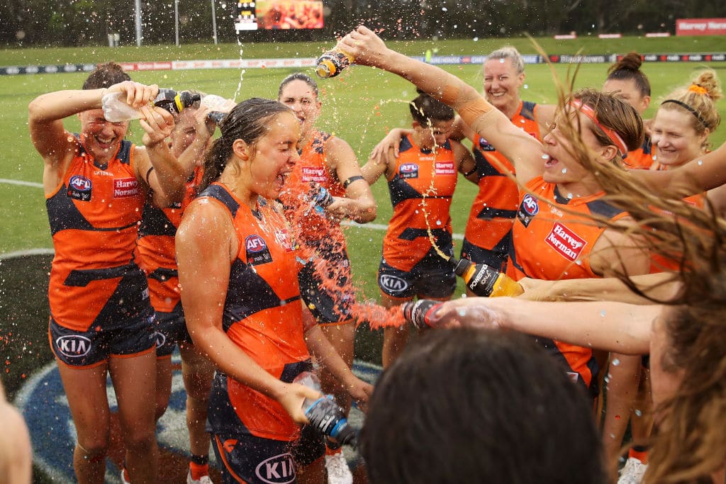 SYDNEY, AUSTRALIA - FEBRUARY 13: Georgia Garnett of the Giants is showered with Powerade as the Giants celebrate victory in the round three AFLW match between the Greater Western Sydney Giants and the Gold Coast Suns at Blacktown International Sportspark on February 13, 2021 in Sydney, Australia. (Photo by Mark Kolbe/Getty Images)