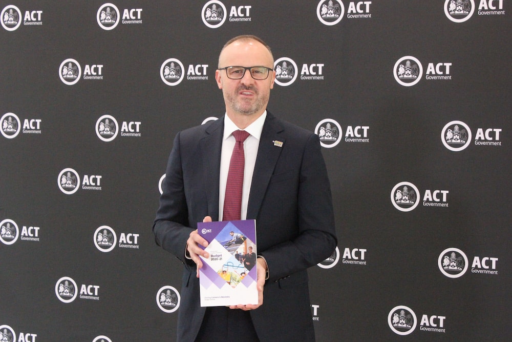 ACT Chief Minister Andrew Barr holds a copy of the 2020-21 ACT Budget.