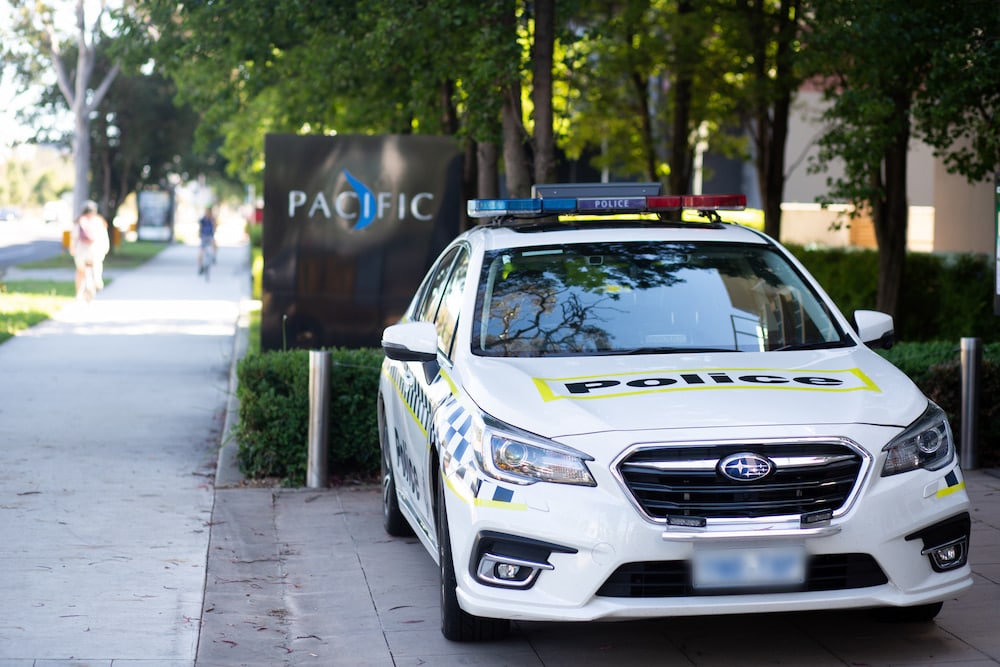 A police car is parked in front of a hotel in Canberra. The WA COVID-19 outbreak has raised questions about hotel quarantine.