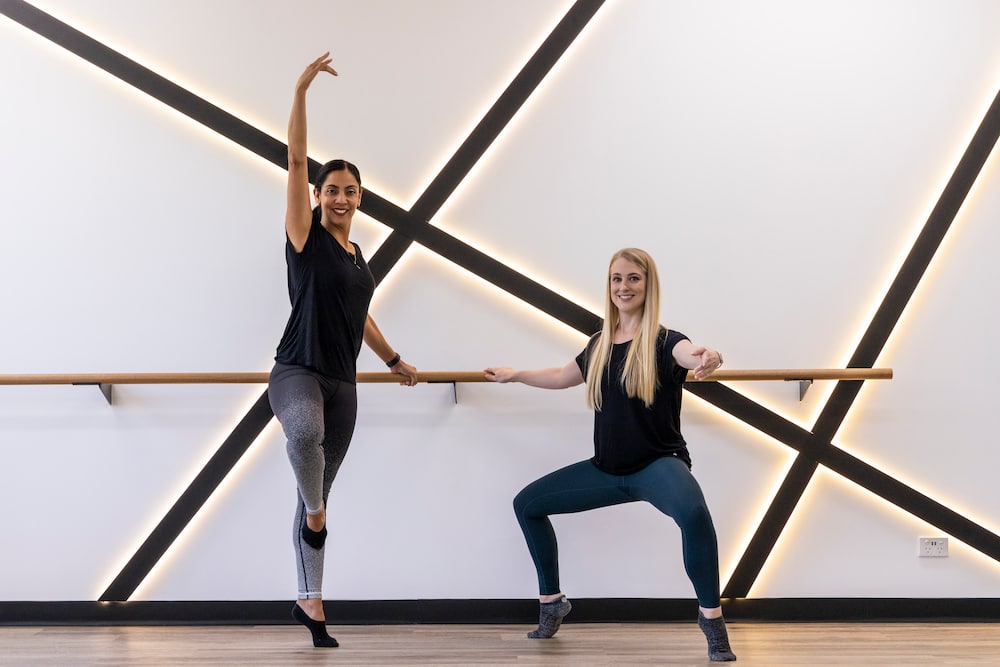 Lorena Kanellopoulos and Lauren McBryde show some positions from an Xtend Barre workout