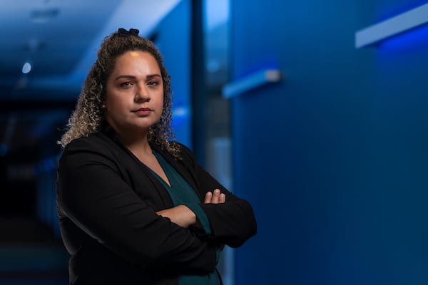 Torres Strait Islander woman in business suit with arms crossed at the Australian National University