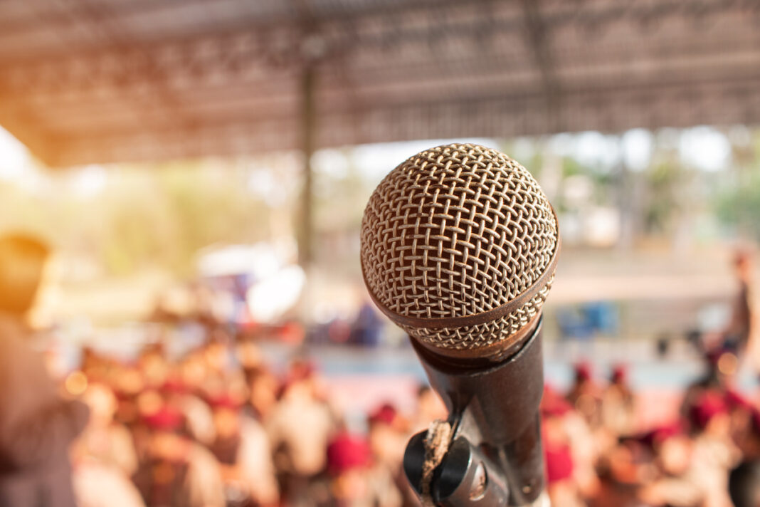Youth Week in Canberra will involve live performances from local musicians, as symbolised by this photo of a microphone with an out of focus outdoor crowd in the background