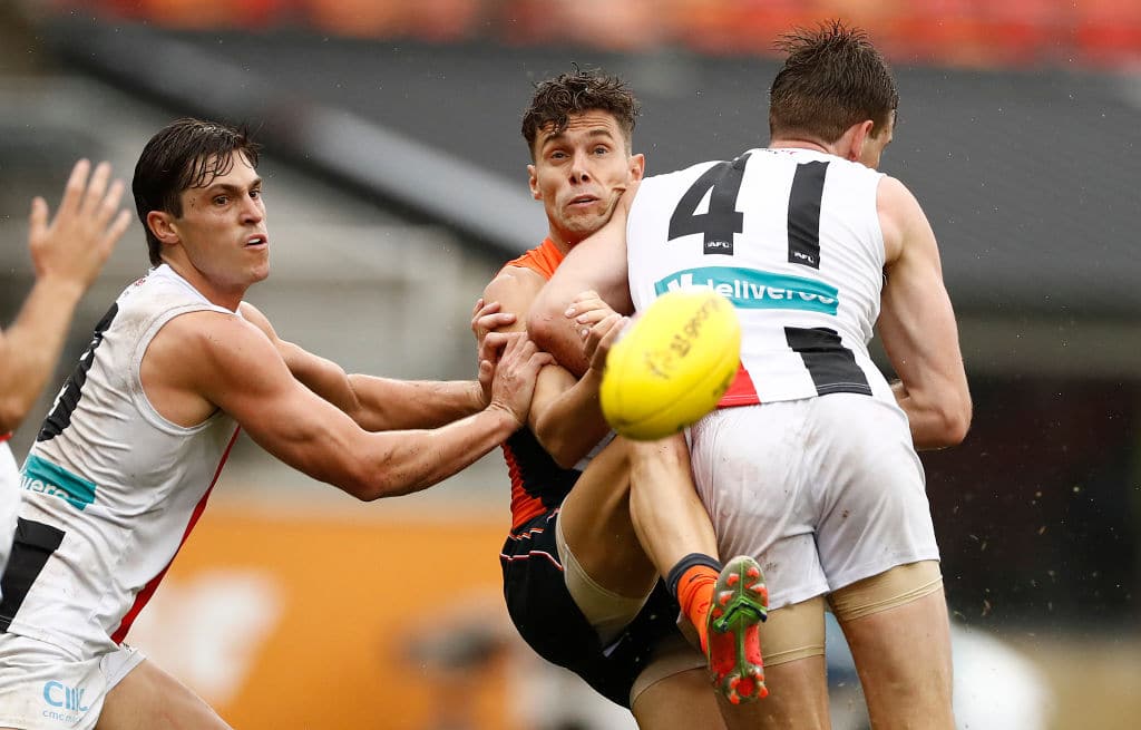 SYDNEY, AUSTRALIA - MARCH 21: Josh Kelly of the Giants is tackled by Paul Hunter of the Saints during the round one AFL match between the GWS Giants and the St Kilda Saints at GIANTS Stadium on March 21, 2021 in Sydney, Australia. (Photo by Ryan Pierse/Getty Images)