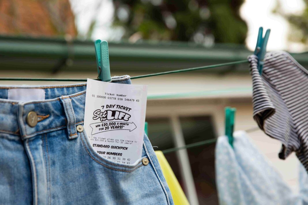 lottery ticket in pocket of jeans hanging on clothesline