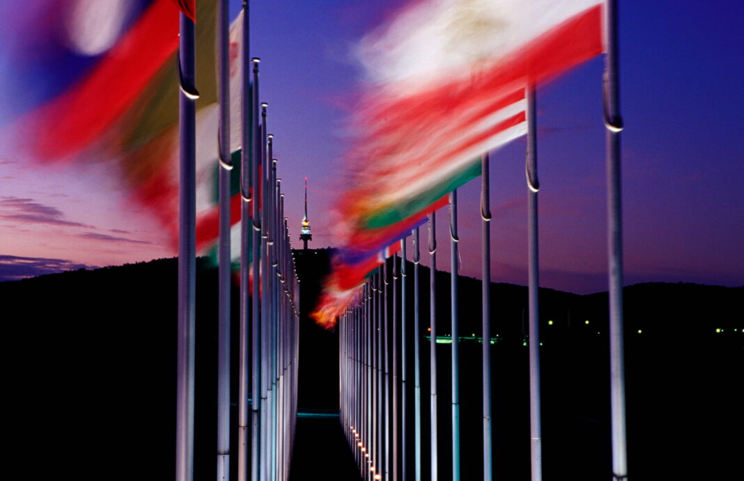 Commonwealth Place flags at night looking towards Black Mountain Tower in Canberra