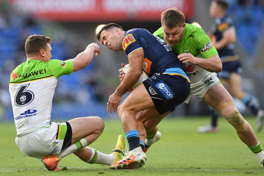 GOLD COAST, AUSTRALIA - AUGUST 22: Corey Thompson of the Titans is tackled during the round 15 NRL match between the Gold Coast Titans and the Canberra Raiders at Cbus Super Stadium on August 22, 2020 in Gold Coast, Australia. (Photo by Matt Roberts/Getty Images)