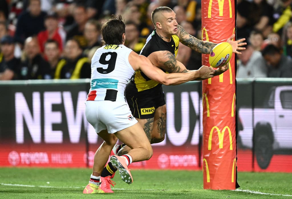 GOLD COAST, AUSTRALIA - OCTOBER 09: Dustin Martin of the Tigers handballs whilst being tackled by Jack Steele of the Saints during the AFL Second Semi Final match between the Richmond Tigers and the St Kilda Saints at Metricon Stadium on October 09, 2020 in Gold Coast, Australia. (Photo by Quinn Rooney/Getty Images)